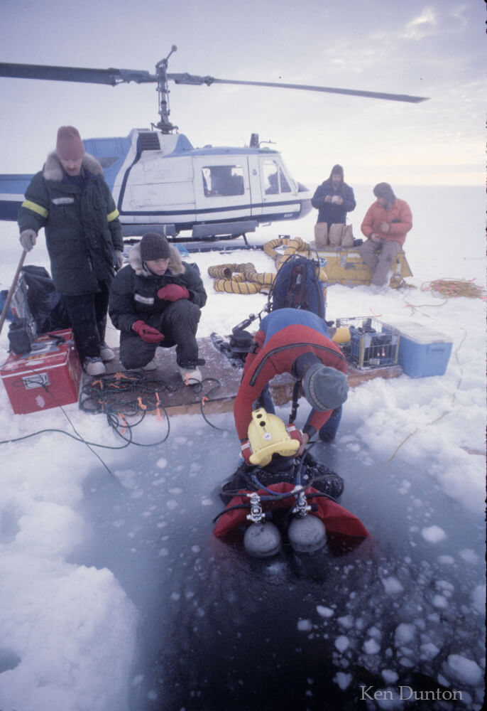 A classic helo based ice dive in February 1978 to locate DS-11. Diver is Jim Hanes with Ken Dunton assisting